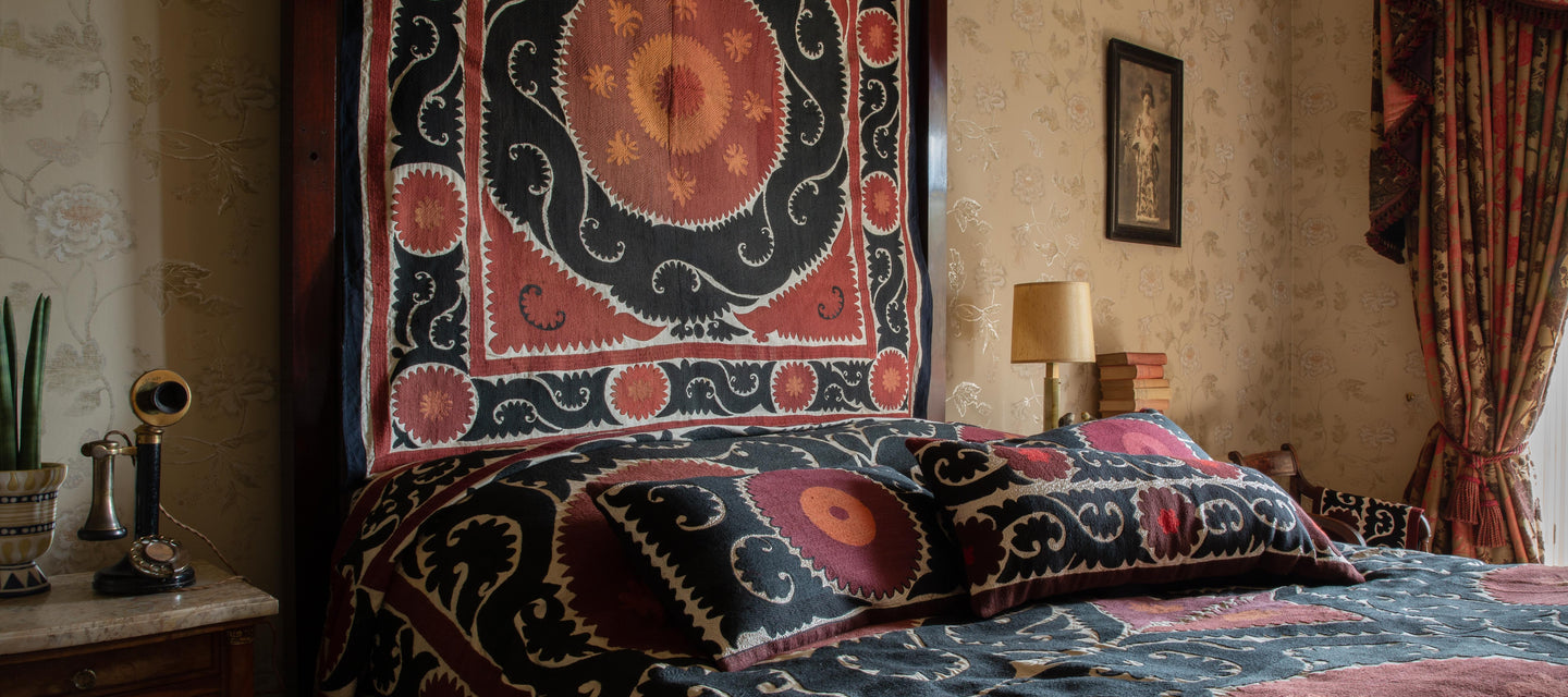 View of the Vintage Hand-Embroidered Suzani Cushion - Gulshan Family Cushion A from our beautiful limited-edition Vintage Suzani Cushions alongside other Vintage Hand-Embroidered Suzani Cushion.