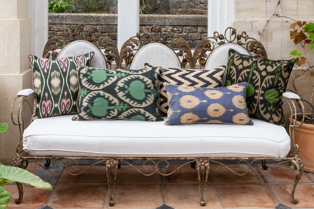 View of the beautiful beautiful Sage Green Pomegranate Silk Ikat Cushions on a beautiful metal-frame sofa amongst other Silk Ikat cushions. 
