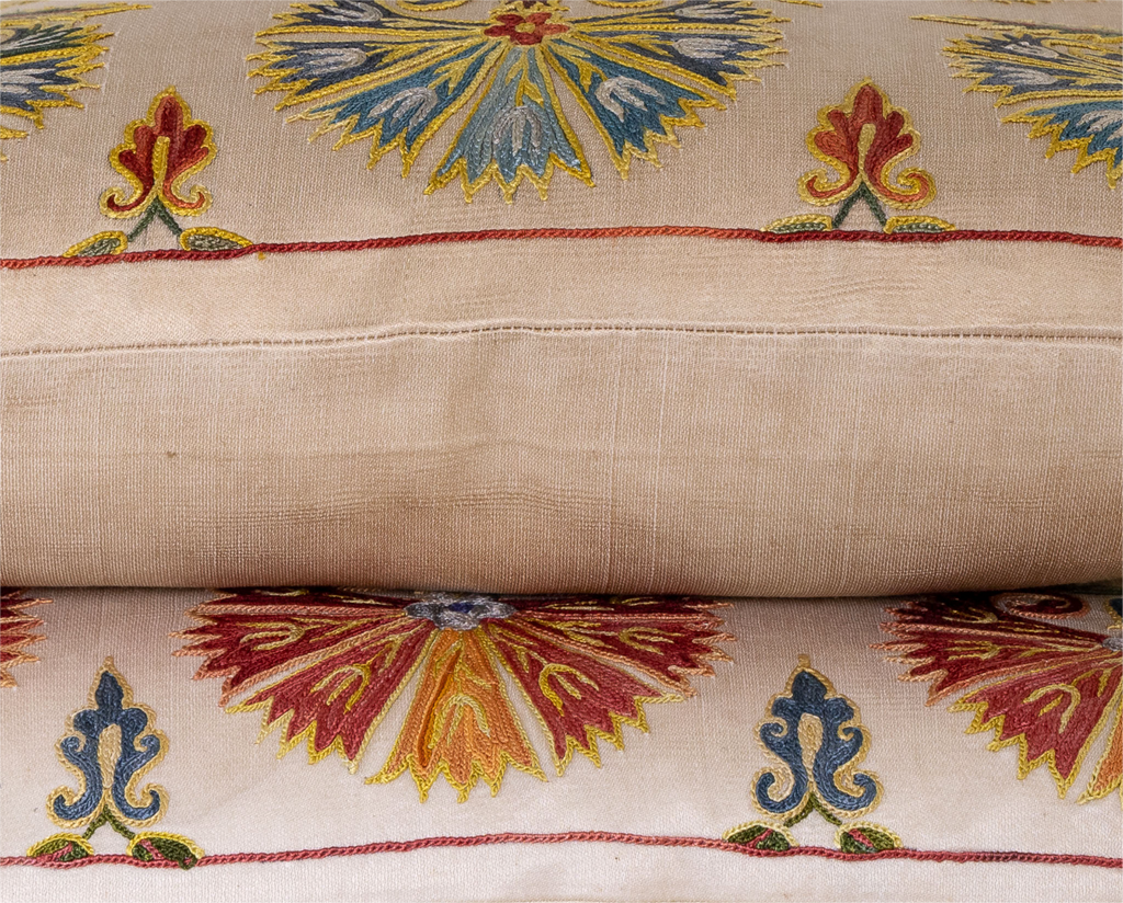 Side view of the luxurious hand-embroidered Blue Carnations with Red Border Silk cushion.