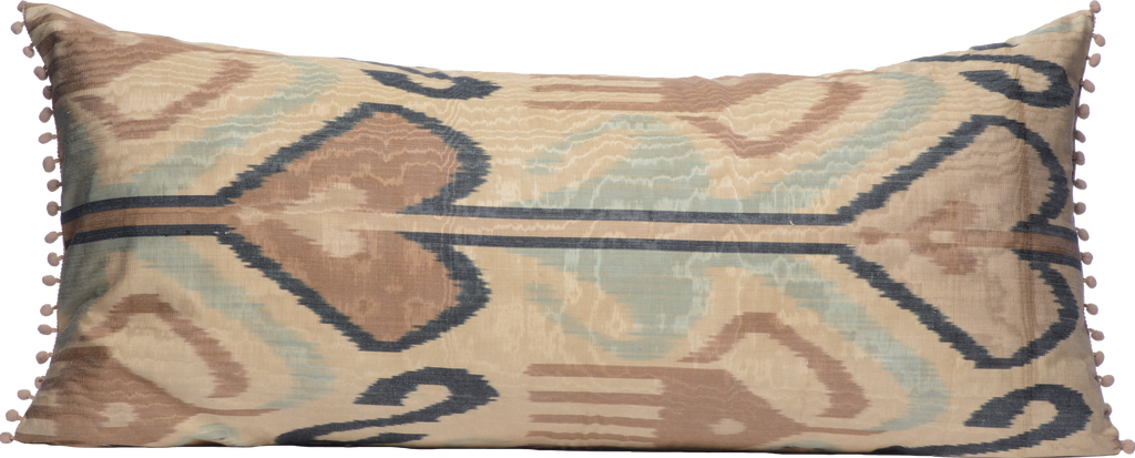 Back view of the hand woven reversible Silk Ikat bolster cushion with beautiful purple blue pattern on cream background with pompoms