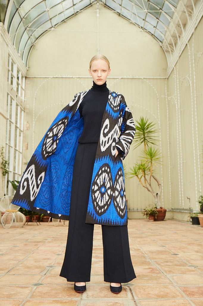 Model wearing Anor’s Silk Ikat Chapan Coat – Sitora with a blue 100% silk lining