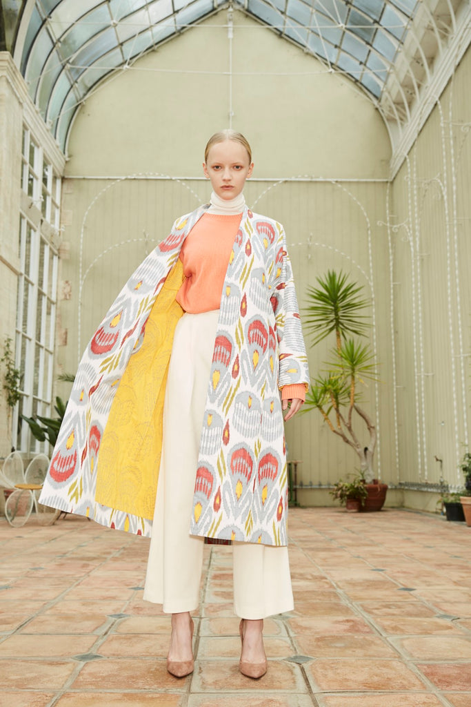 Model wearing Anor’s Silk Ikat Chapan Coat – Farnira with a yellow 100% silk lining