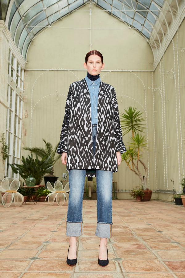 Model wearing a classic cut Silk Ikat Munira jacket. The fabric is hand woven and hand embroidered with exquisite detail and a 100% silk lining ensures a wonderfully luxurious wear.