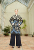 Model wearing Anor’s traditional Uzbek Chapan Silk Ikat Coat – Aziza with a 100% silk lining
