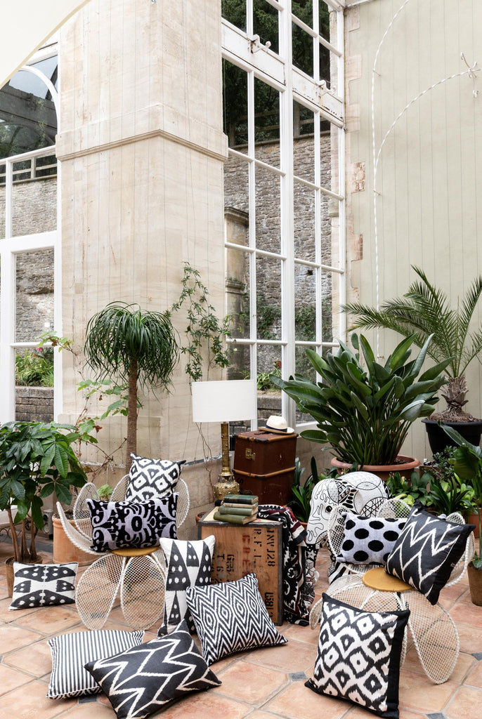 View of many beautiful Black and White Patterned Silk Ikat cushion in a large room.